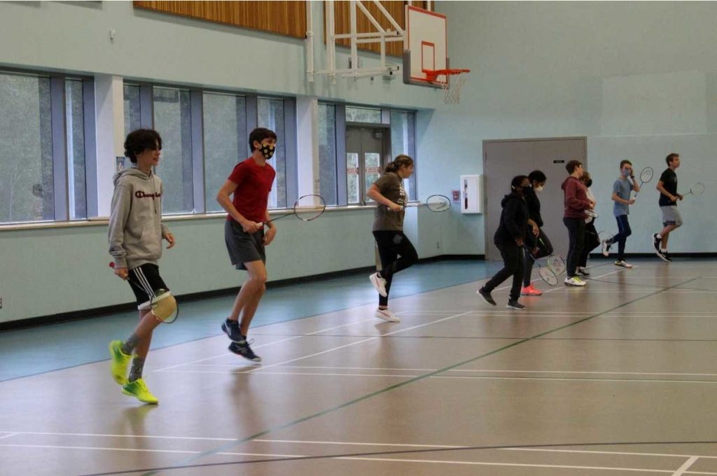 Players of all levels begin the session with a warmup that starts with running and hopping on the spot